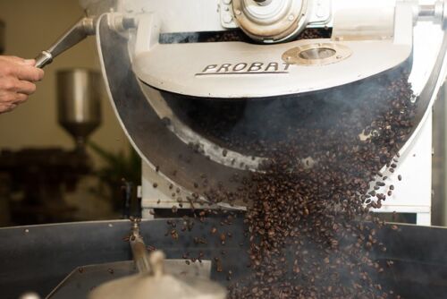 Types of Coffee Roasts, coffee beans coming out of a roaster