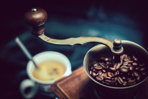 What Coffee Beans Are Best For Espresso, a coffee grinder next to a cup of Joe